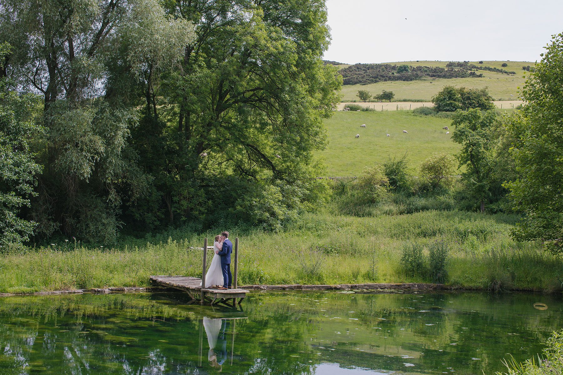 bride and groom on jetty