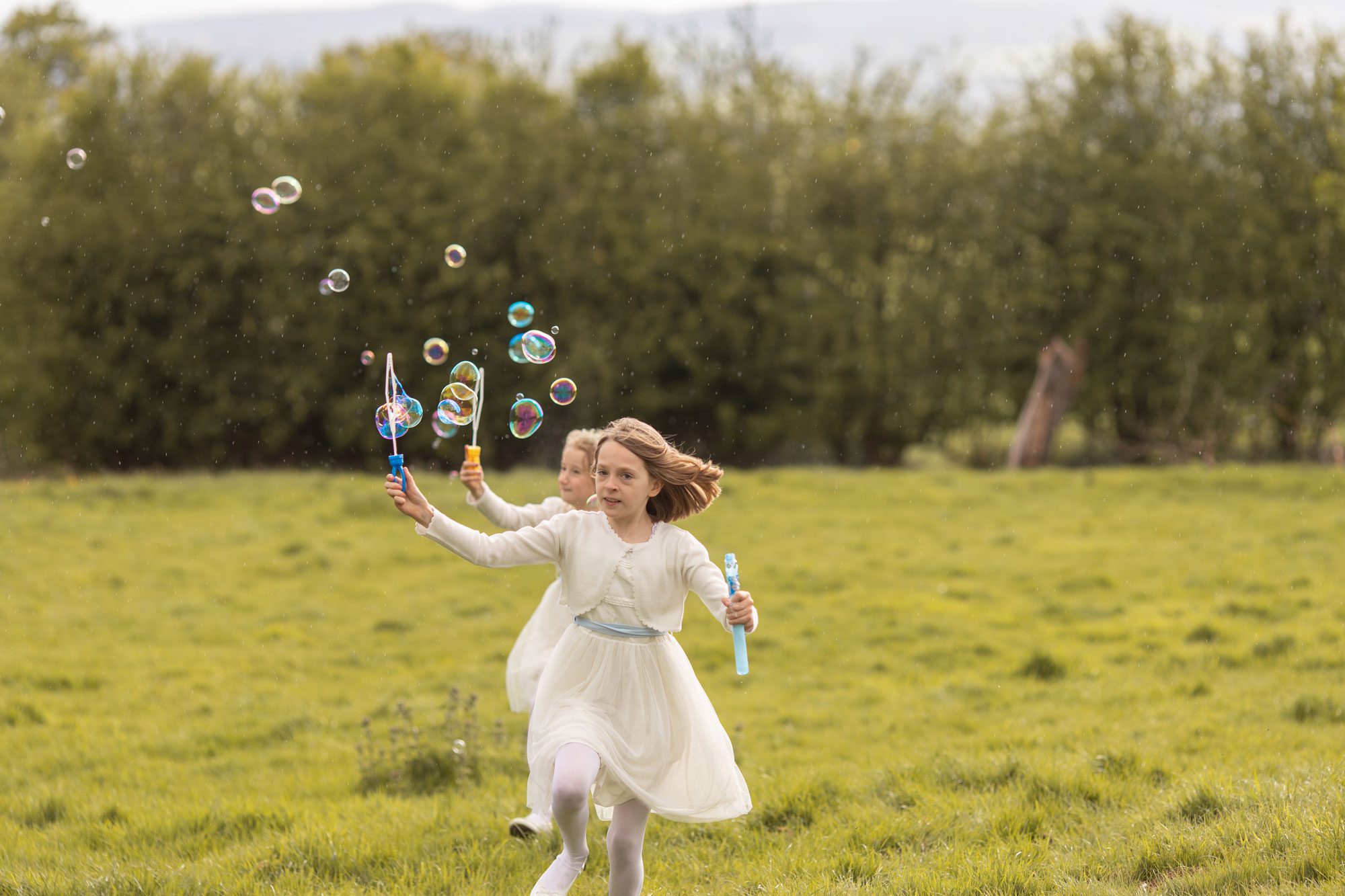 bridesmaids chasing bubbles